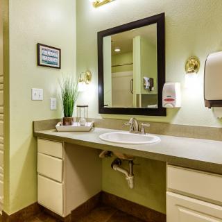 A well-decorated bathroom with a sink, mirror, and countertop.