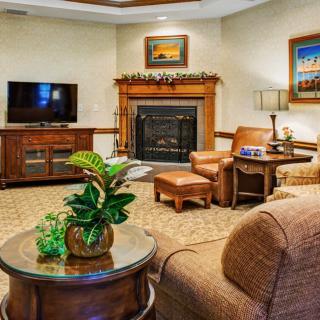 A cozy living room featuring a fireplace, comfortable seating, and modern decor.