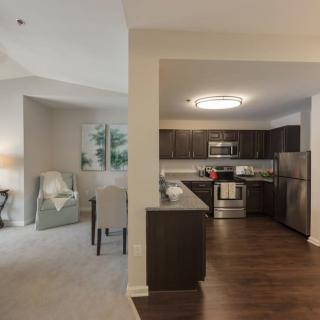 A modern apartment featuring an open floor plan with a kitchen and living area.