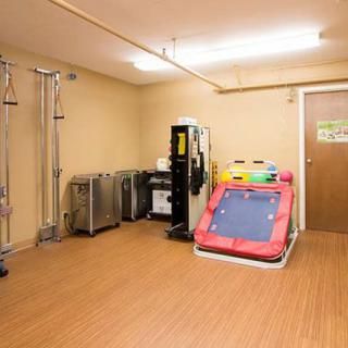 A rehabilitation room with gym equipment for physical therapy exercises.