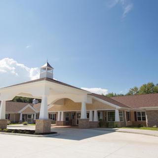 A welcoming exterior view of a building under a clear blue sky.