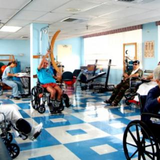 Patients in a rehabilitation center engaged in therapy and exercises.