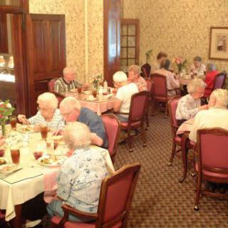 A group of seniors enjoying a meal together at a restaurant.