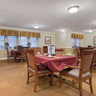 A cozy dining area with neatly arranged tables and chairs, set for service.