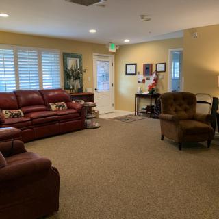 A cozy living room with comfortable seating and warm lighting.