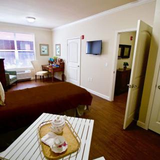 A cozy bedroom featuring warm colors, a neatly made bed, and decor that creates a welcoming atmosphere.