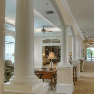 A modern living room interior with elegant columns and archways.