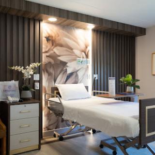 A modern patient room in a hospital featuring contemporary design elements and a calming atmosphere.