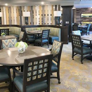 A well-decorated dining area featuring multiple tables and chairs, with a modern interior design.