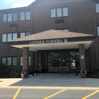 Entrance to a residential apartment building with the name 'Lexington Towers II'.