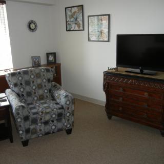 Cozy living room with an armchair and television.