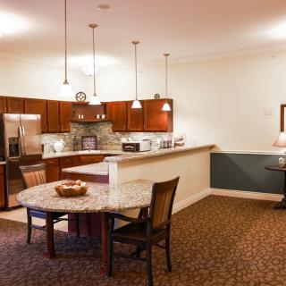 A modern kitchen and dining area with contemporary furnishings and warm lighting.