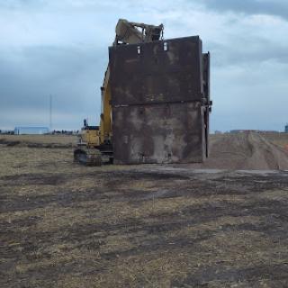 A bulldozer operating on a construction site, preparing the land.