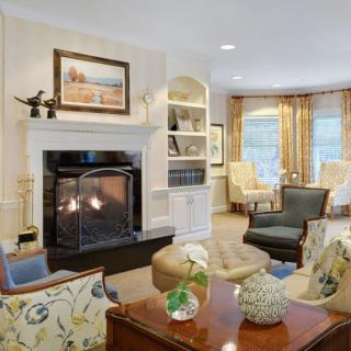 A cozy living room with a fireplace, comfortable seating, and elegant decor.