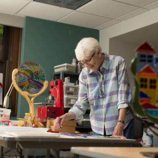 A woman painting in a creative art studio.