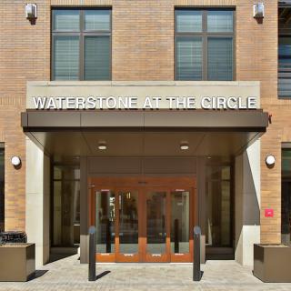 Entrance to Waterstone at the Circle with glass doors and a visible sign.