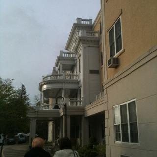 A multi-story building with prominent balconies and an urban setting.