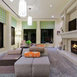 A modern living room featuring a cozy fireplace and stylish furniture.