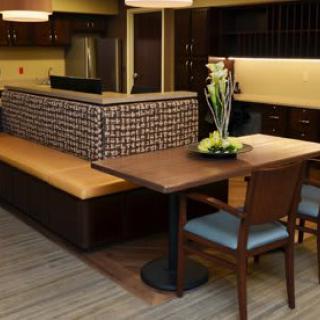 A modern dining area with a wooden table, chairs, and bench seating.