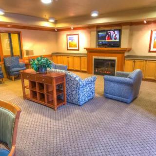 A cozy living room with comfortable furnishings and a fireplace.