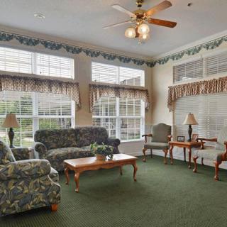 A cozy living room with stylish furniture and large windows, allowing plenty of natural light.