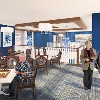 A modern senior living common area with people engaging in activities.