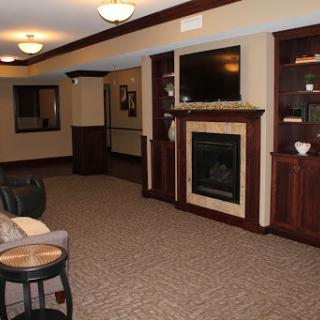 A cozy living room featuring a fireplace and comfortable furniture, designed for relaxation.