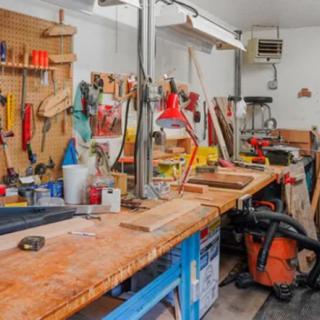 A well-equipped woodworking workshop featuring a variety of tools and machinery on a workbench.