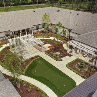 A beautifully designed outdoor garden featuring lush greenery and well-defined pathways.