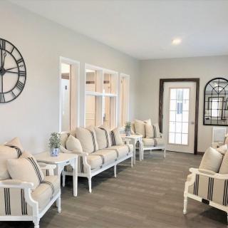 A bright waiting room with comfortable seating and decorative elements.