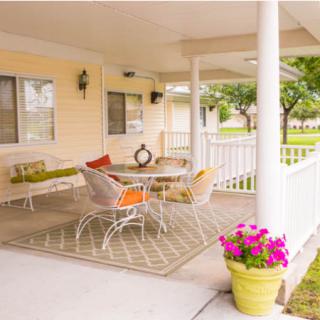 Cozy outdoor patio with comfortable seating and vibrant decor.