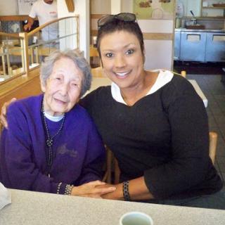 A heartwarming moment captured between two women enjoying each other's company at a restaurant.