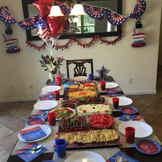 A festive table set for a patriotic celebration with delicious food and vibrant decorations.