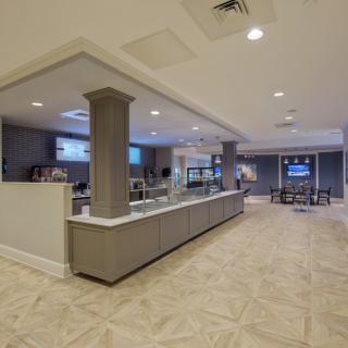 A spacious and modern hotel lobby featuring a reception desk and comfortable seating area.