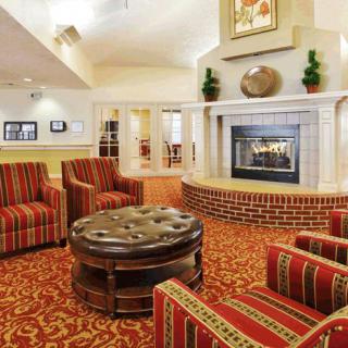A cozy living room with comfortable seating and a fireplace.