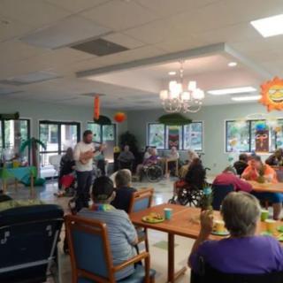 A community gathering taking place in a decorated indoor area.