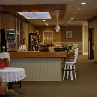 A cozy dining area with a counter and seating, softly lit for a warm atmosphere.