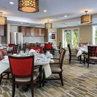 A beautifully designed dining area with elegant tables and chairs, accented by stylish lighting fixtures.