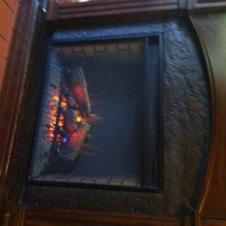 An electric fireplace providing warmth and ambiance to a cozy room.