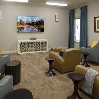 A modern living room with comfortable seating and a large television.