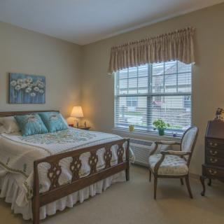Cozy bedroom with a wooden bed frame and elegant decor.