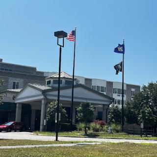 A building with flags flying on a clear day.