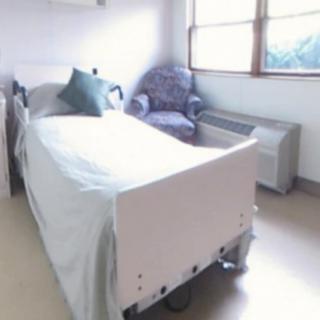 A clean and bright hospital room with a single bed and window.
