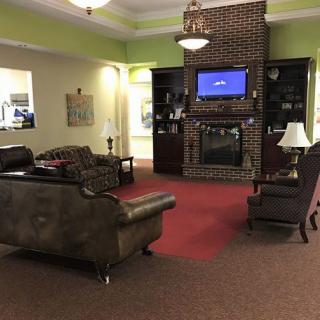 A cozy living room with a fireplace, TV, and comfortable seating.