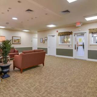 A spacious lobby with comfortable seating and decorative plants.
