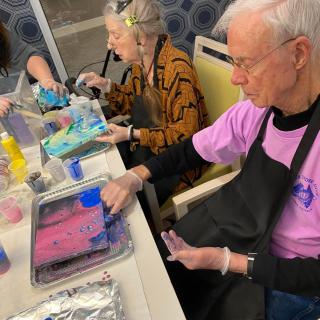 Seniors engaged in a creative painting workshop.