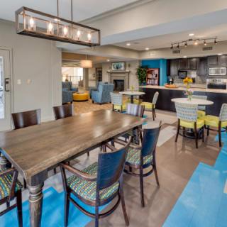 Modern open-space dining and kitchen area with contemporary furniture and lighting.