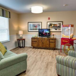 Cozy living room with a TV and popcorn machine.