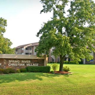 Spring Park Christian Village building with surrounding trees and lawn.