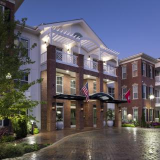 A beautifully lit hotel building with a welcoming entrance at night.
